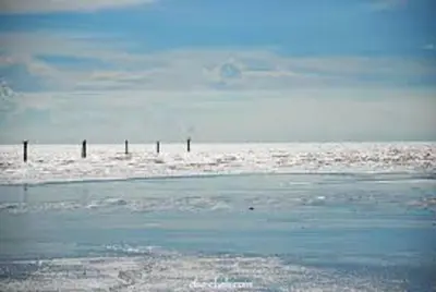 a beach with a body of water with snow and ice at The One Boutique Hotel in Sekincan