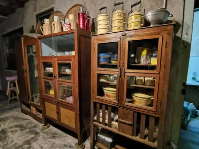 a pair of wooden cabinets with dishes in them at Nature Fruit Farm - Private Estate in Balik Pulau