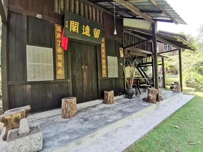 a building with a bunch of logs in front of it at Nature Fruit Farm - Private Estate in Balik Pulau