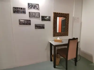 a table with a chair and a mirror on a wall at Nature Fruit Farm - Private Estate in Balik Pulau