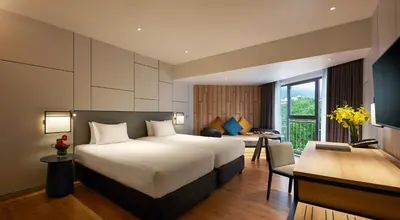 a hotel room with a bed and a desk at PARKROYAL Penang Resort in Batu Ferringhi