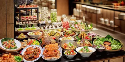 a buffet with many different dishes of food on a table at PARKROYAL Penang Resort in Batu Ferringhi