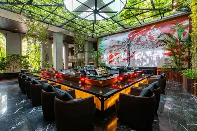 a dining room with a long table and chairs at PARKROYAL Penang Resort in Batu Ferringhi