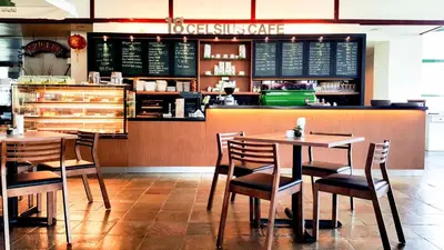 a restaurant with tables and chairs in front of a counter at Copthorne Hotel Cameron Highlands in Cameron Highlands