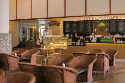 a restaurant with rattan chairs and a counter with a counter at Copthorne Hotel Cameron Highlands in Cameron Highlands