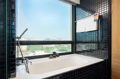 a bath tub in a bathroom with a window at G Hotel Gurney in George Town