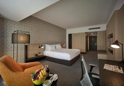 a hotel room with a bed and a desk at G Hotel Gurney in George Town