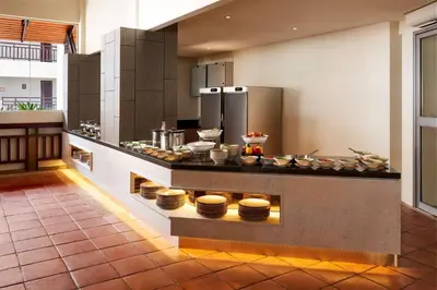 a kitchen with a counter with plates on it at DoubleTree by Hilton Damai Laut in Lumut
