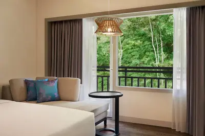 a hotel room with a bed and a window at DoubleTree by Hilton Damai Laut in Lumut