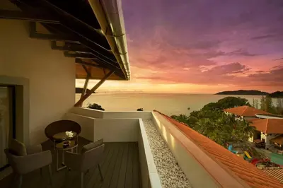 a building with a balcony with a view of the ocean at DoubleTree by Hilton Damai Laut in Lumut