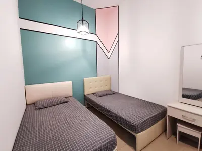 a room with two beds and a tv at The Woodz Homestay - 3 Bedroom in Cameron Highlands