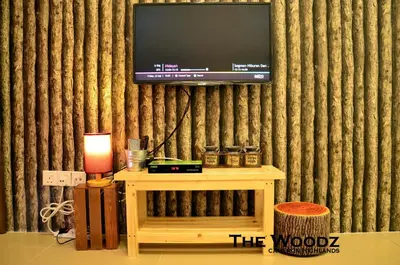 a living room with a tv on a wall at The Woodz Homestay - 3 Bedroom in Cameron Highlands