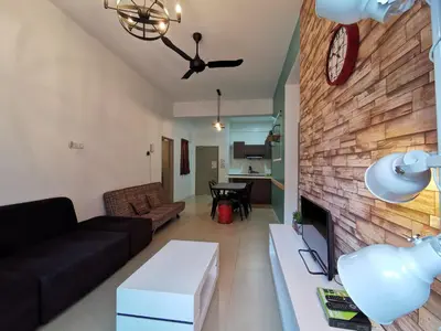 a living room with a couch and a brick wall at The Woodz Homestay - 3 Bedroom in Cameron Highlands