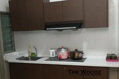 a kitchen with a sink and a stove top oven at The Woodz Homestay - 3 Bedroom in Cameron Highlands