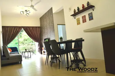 a living room with a table and chairs at The Woodz Homestay - 3 Bedroom in Cameron Highlands