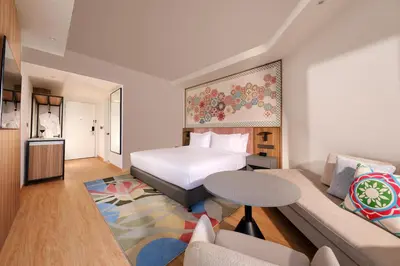 a hotel room with a bed and a couch at M Social Resort Penang in George Town