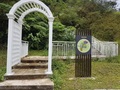 a white gate and stairs with a sign next to it at NAZMI & LINDA CAMERON HOMESTAY in Cameron Highlands