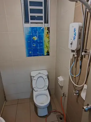 a small bathroom with a toilet and a window at NAZMI & LINDA CAMERON HOMESTAY in Cameron Highlands