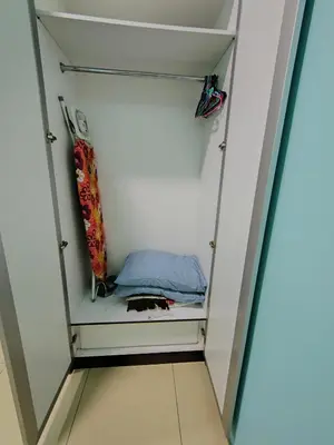 a walk in closet with a glass door at NAZMI & LINDA CAMERON HOMESTAY in Cameron Highlands