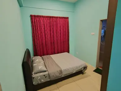 a bedroom with a bed with a red curtain at NAZMI & LINDA CAMERON HOMESTAY in Cameron Highlands
