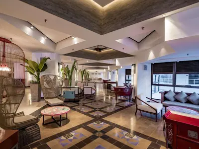 a living room with a couch and chairs and a table at DoubleTree Resort by Hilton Hotel Penang in Batu Ferringhi