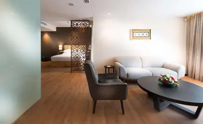a living room with a couch and a table at DoubleTree Resort by Hilton Hotel Penang in Batu Ferringhi