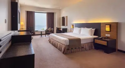 a hotel room with a bed and a desk at Bayview Hotel Georgetown Penang in George Town