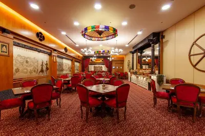 a restaurant with red chairs and tables in a room at Bayview Hotel Georgetown Penang in George Town