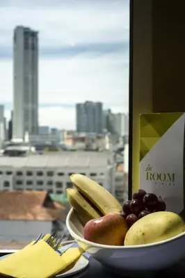 a bowl of fruit on a table with a view of a city at Cititel Penang in George Town