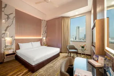 a hotel room with a bed and a desk at Cititel Penang in George Town