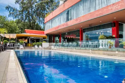 a large swimming pool in front of a building at Hotel Sentral Seaview @ ​Beachfront in George Town