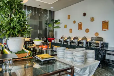 a restaurant with a lot of plates on a table at Hotel Sentral Seaview @ ​Beachfront in George Town