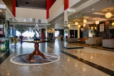 a lobby with a table in the middle of it at Hotel Sentral Seaview @ ​Beachfront in George Town