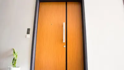 a wooden door in a room with a plant at Octagon Premium Ipoh Town Center by Grab A Stay in Ipoh