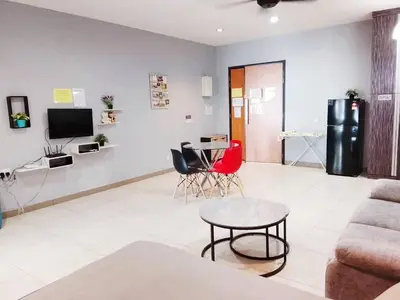 a living room with a couch and a table at Octagon Premium Ipoh Town Center by Grab A Stay in Ipoh