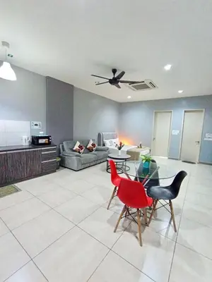 a living room with a couch and a table and chairs at Octagon Premium Ipoh Town Center by Grab A Stay in Ipoh