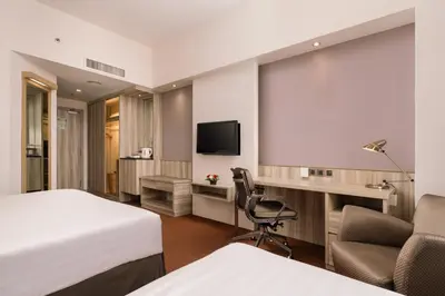 a hotel room with a bed and a flat screen tv at Sunway Hotel Georgetown Penang in George Town