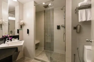 a bathroom with a shower and a sink and a toilet at Sunway Hotel Georgetown Penang in George Town