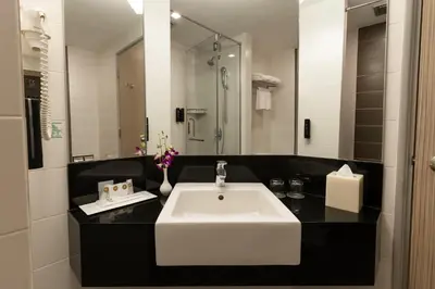 a bathroom with a white sink and a mirror at Sunway Hotel Georgetown Penang in George Town