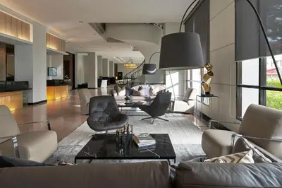 a living room with a couch and a table at AC Hotel by Marriott Penang in Bayan Lepas