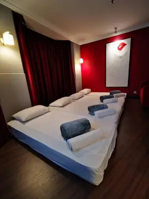 a large bed in a room with a red wall at Regalodge Hotel & Spa Ipoh in Ipoh