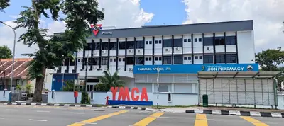 a white building with a sign on the side of it at YMCA Penang in George Town