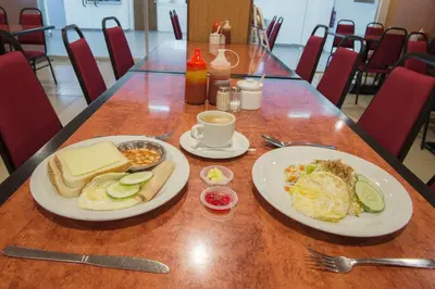 a table with two plates of breakfast food on it at YMCA Penang in George Town