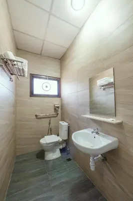 a bathroom with a toilet and a sink at YMCA Penang in George Town