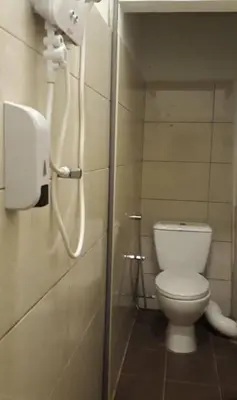 a bathroom with a white toilet in a stall at Max Ferringhi Hotel in Batu Ferringhi