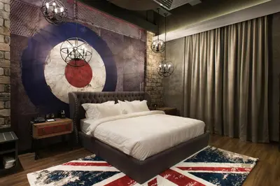 a bedroom with a large bed and a rug at Vangohh Eminent Hotel & Spa in Bukit Mertajam