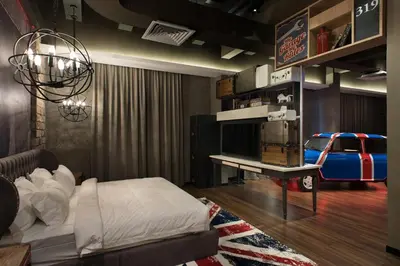 a bedroom with a bed and a table with a car on it at Vangohh Eminent Hotel & Spa in Bukit Mertajam