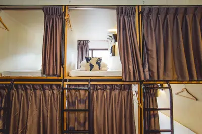a room with two bunk beds and a mirror at Traveller Bunker Hostel in Cameron Highlands