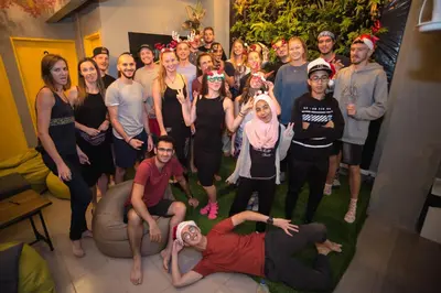a group of people posing for a picture in a room at Traveller Bunker Hostel in Cameron Highlands