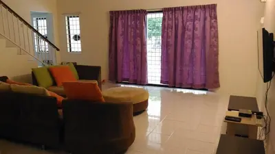 a living room with purple curtains and a couch at J&P Homestays House 1 in Kampar